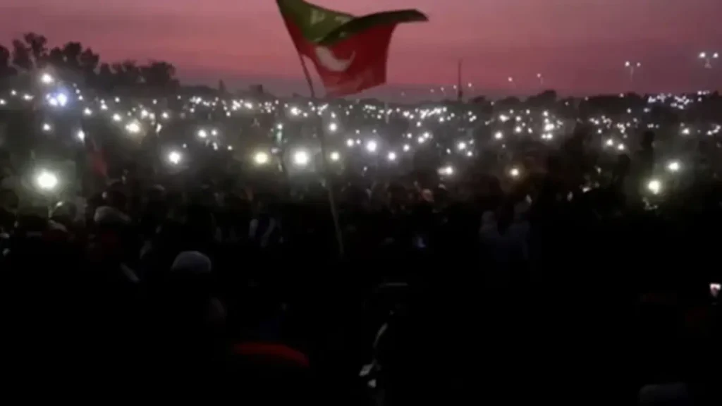 PTI Lahore rally crowd holding up cellphones for light