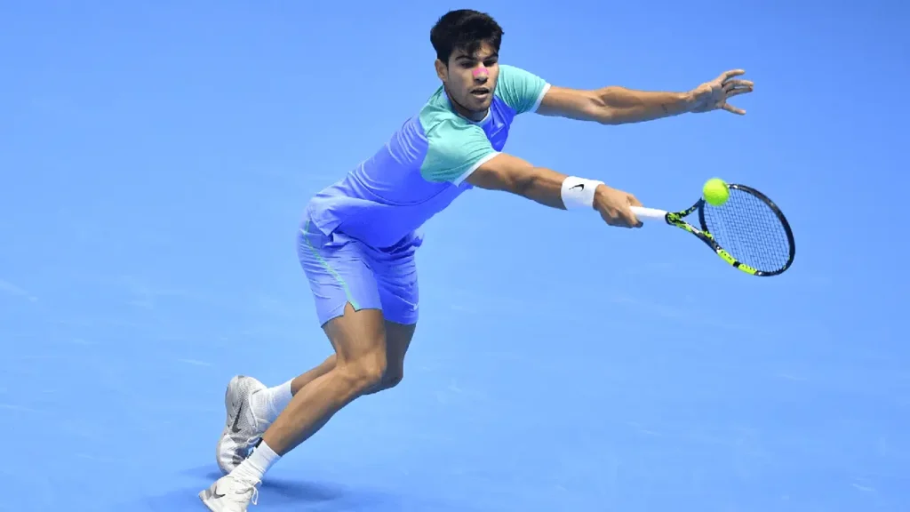 Alcaraz hits a backhand against Andrey Rublev in Turin