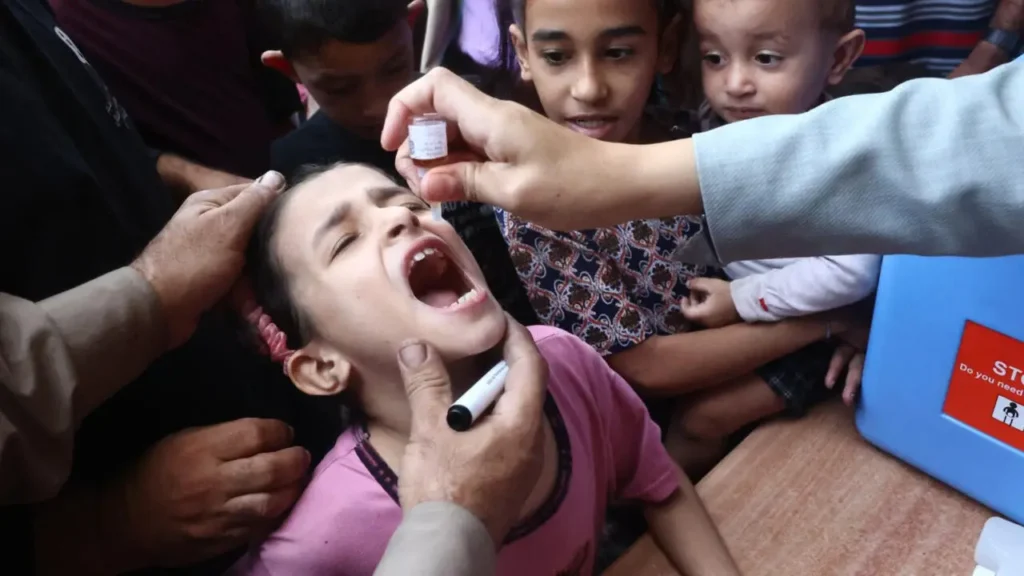 Health workers administering polio vaccine in Gaza clinic