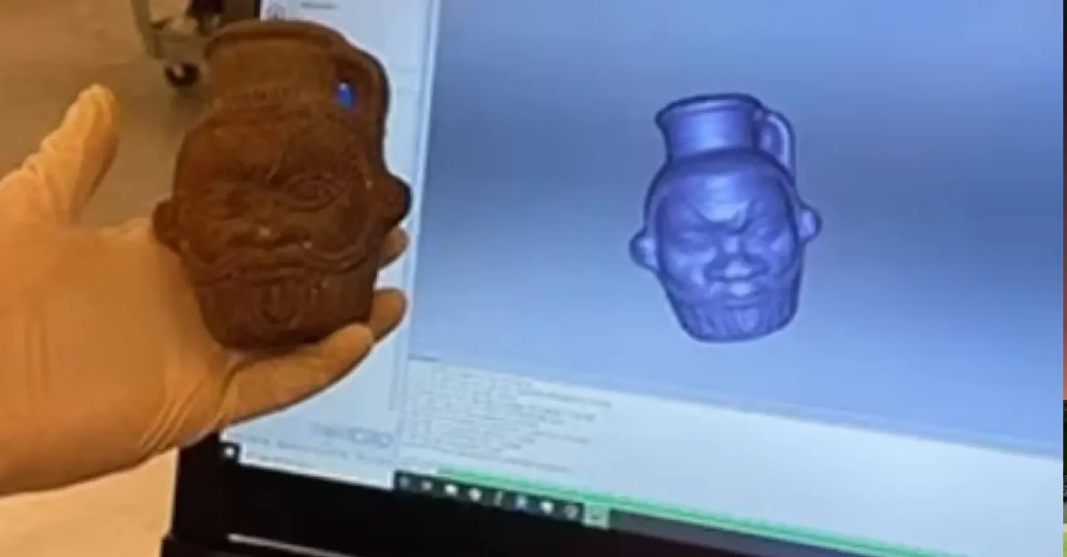 "Ancient Bes-shaped mug used in Egyptian rituals on display" "Chemical residue analysis of ancient Egyptian ritual mug" "Depiction of Bes, fertility deity, on a 2,000-year-old artifact" "Ingredients found in ancient Egyptian psychedelic concoction"