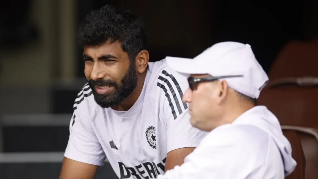 "Jasprit Bumrah bowling during an international cricket match" "Indian cricket team squad for Champions Trophy 2025" "Ajit Agarkar addressing a press conference at BCCI headquarters"