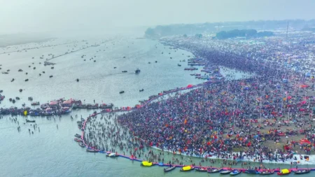 Aerial view of pilgrims bathing at Triveni Sangam during Maha Kumbh 2025 Devotees taking a holy dip at the confluence of Ganga, Yamuna, Saraswati Crowd management and surveillance at Maha Kumbh 2025