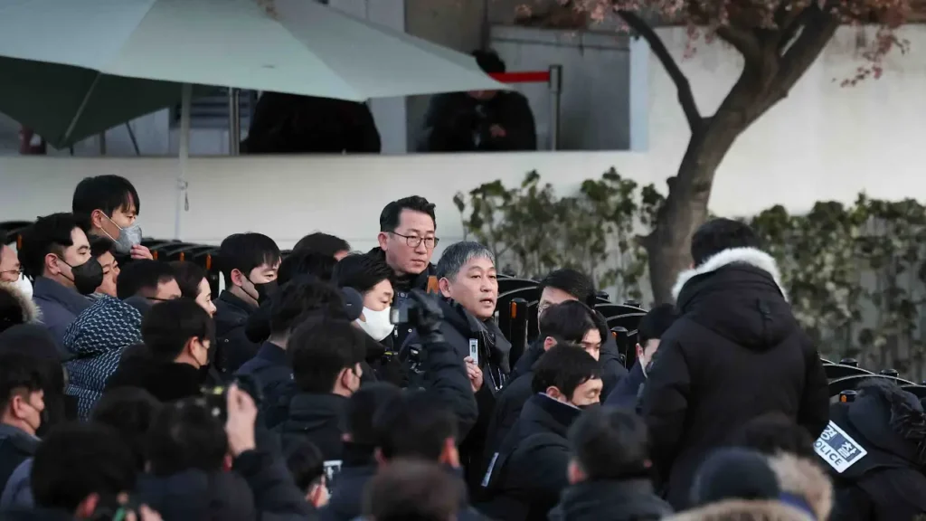 "South Korean police outside Yoon Suk Yeol's residence during the arrest standoff." "Pro-Yoon supporters holding all-night prayers and protests."