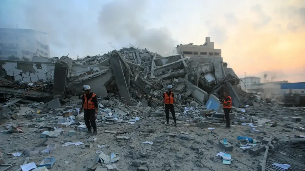 Aid trucks entering Gaza – Humanitarian trucks delivering aid to Gaza after the ceasefire. Ceasefire talks – Israeli and Hamas representatives engaging in ceasefire negotiations. Gaza destruction – War-torn buildings in Gaza highlighting the humanitarian crisis.